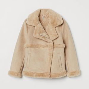 Biker jacket in faux suede w/faux fur lining. Notched lapel, diagonal zip.